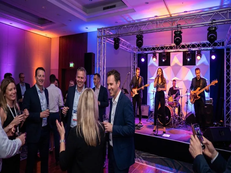 Coverband spielt auf einer Firmenfeier mit tanzenden Gästen
